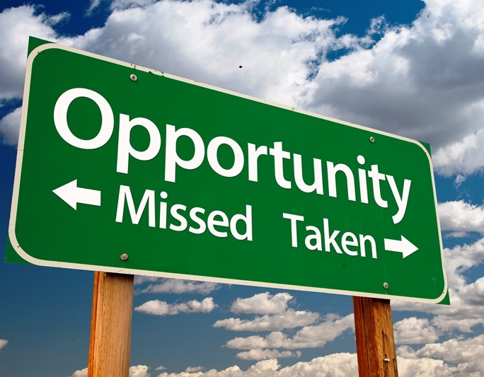 Opportunity Missed and Taken Green Road Sign and Clouds